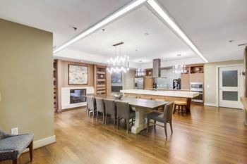 A modern kitchen with a dining table and chairs.